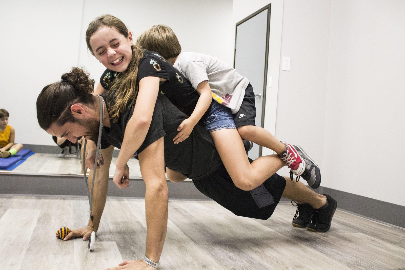 A Lightning Ninja Academy coach training with two young ninjas