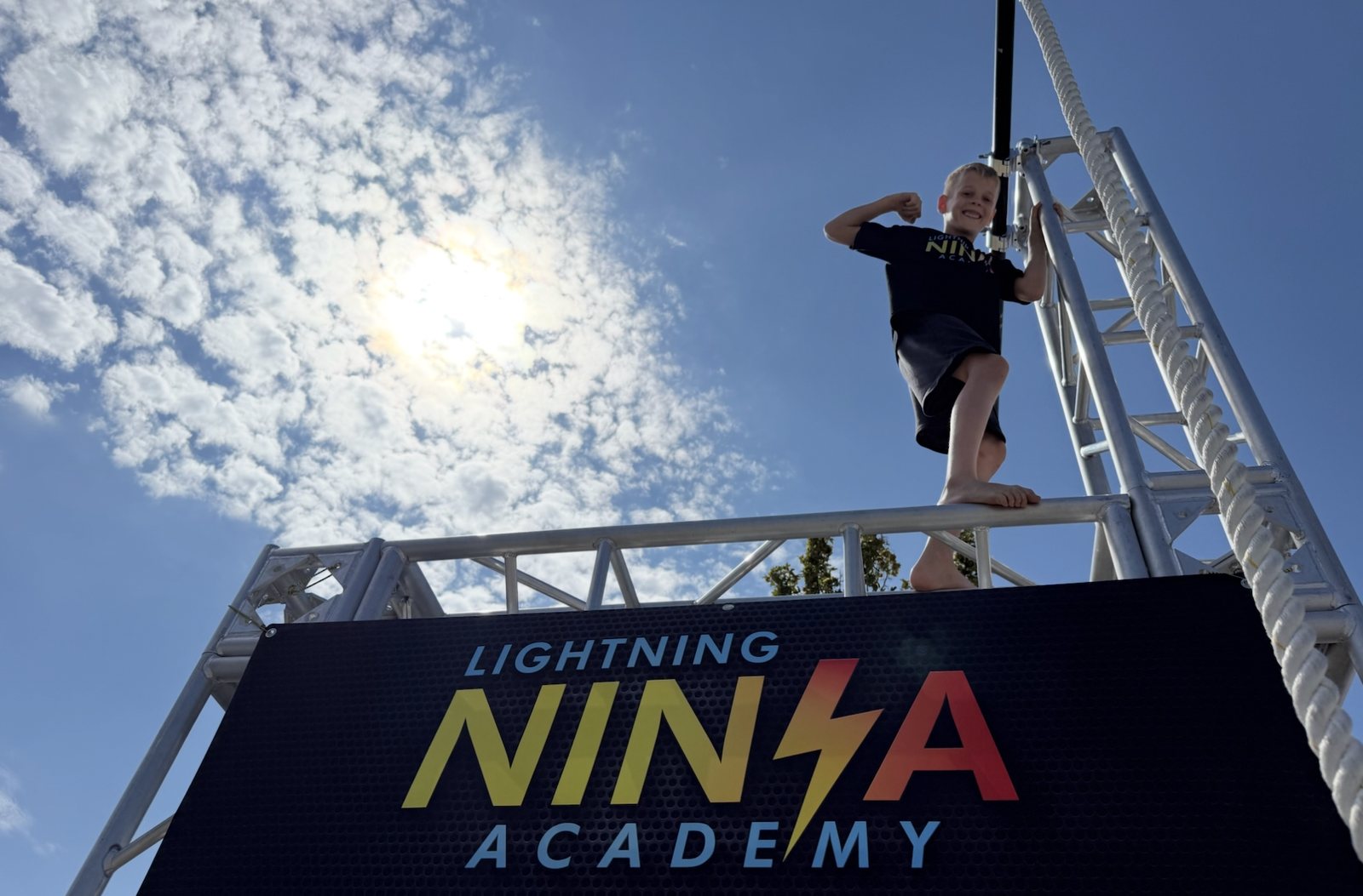 Young ninja flexing on top of the Lightning Ninja Academy rig